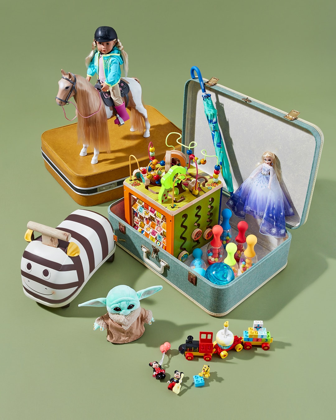 A stack of toys coming out of a suitcase
